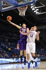 Haskell's Dallas Rudd goes up for the lay in over a Tulsa University player.
